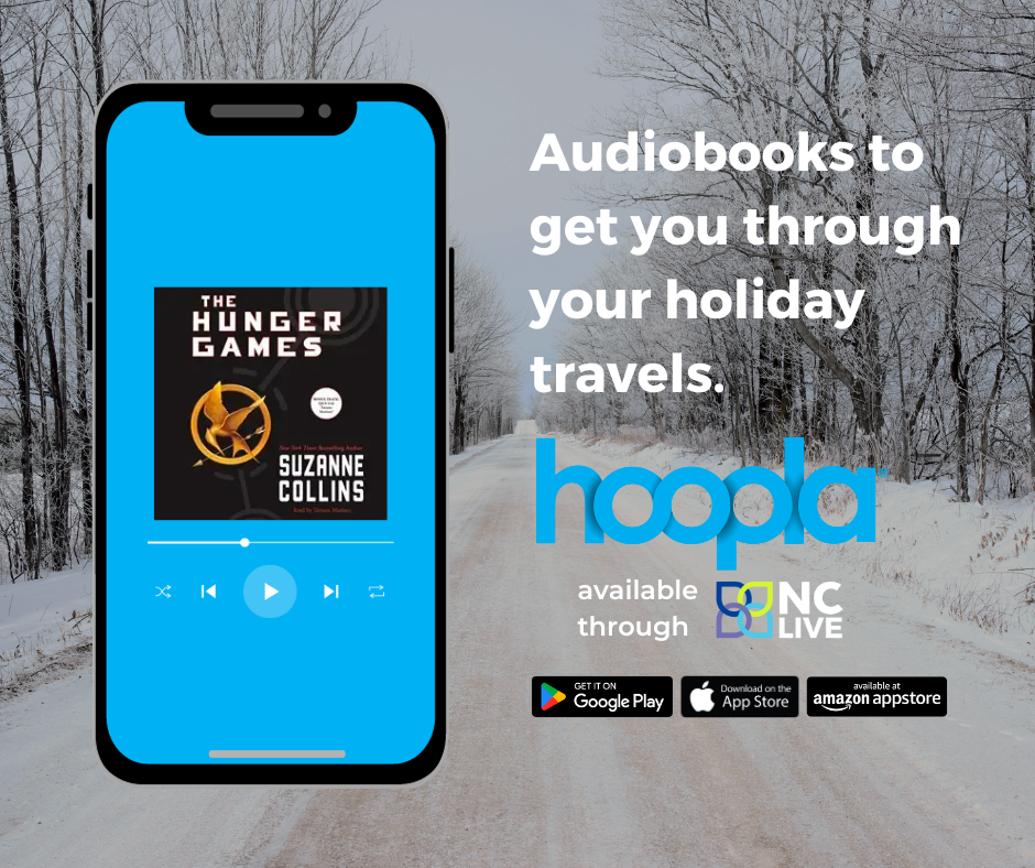 A phone showing an audiobook of the Hunger Games against the background of a snowy road.