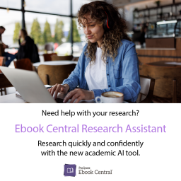A student with curly hair working on a laptop at a cafe.